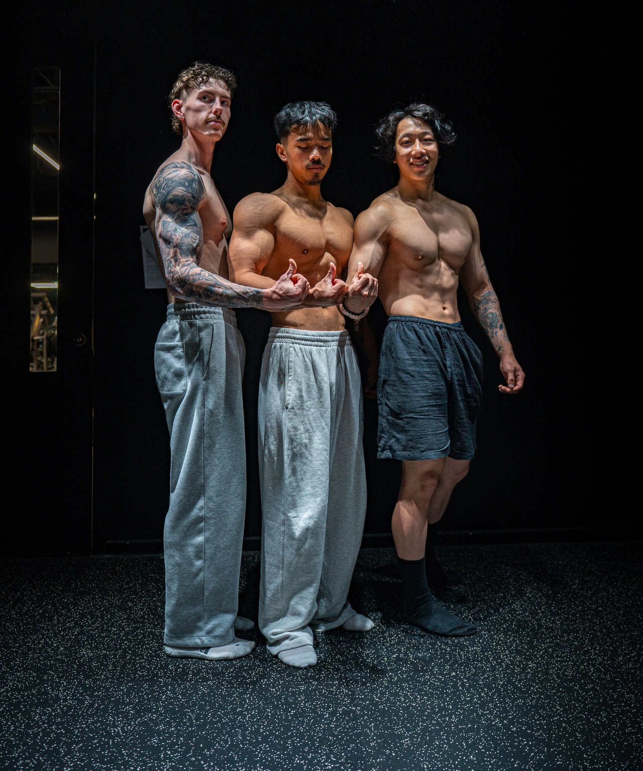 Three members of the team sharing a relaxed moment between poses in the studio.