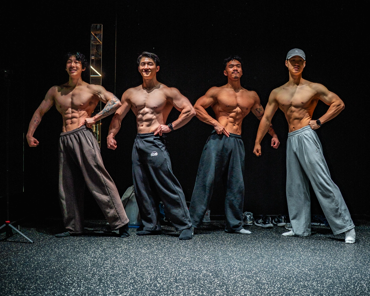 Four members of the BBB team practising poses together.